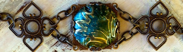 Cobalt Iris Bracelet I embossed the metal and then added alcohol inks in colors of blue and green. I dapped it to get the domed look then sanded and buffed it to bring out the embossed design in the metal and sealed it with clear sealer. It gives it a lovely glow, I just love this technique! Then it is just like working a puzzle, finding just the right pieces to create a bracelet.