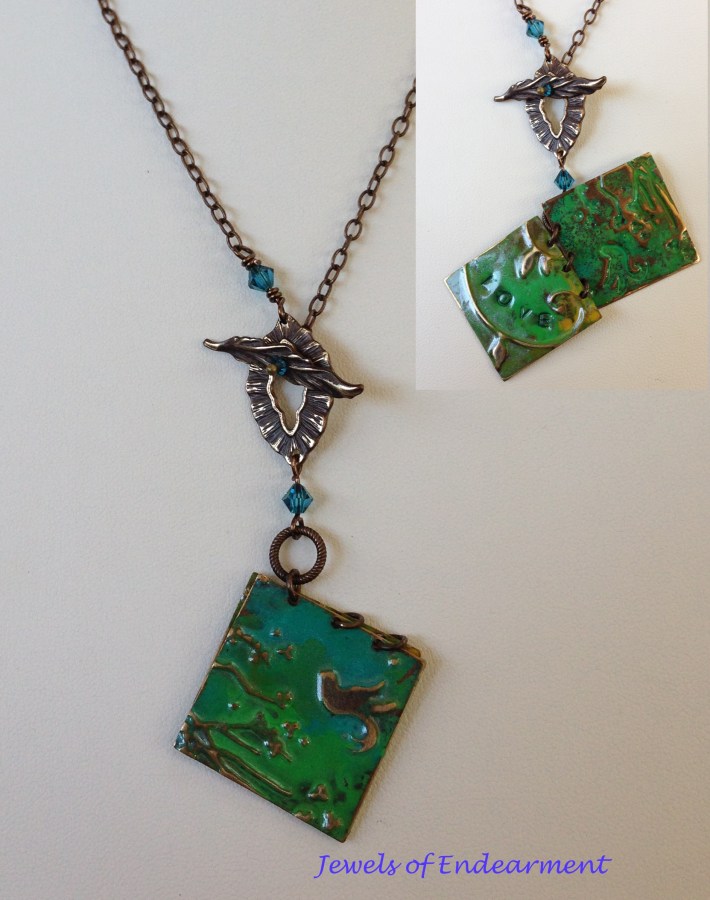 Love Booklet Necklace A brass leaf toggle clasp and a cerulean sky and jade green leaves opens to a page with love handstamped inside.