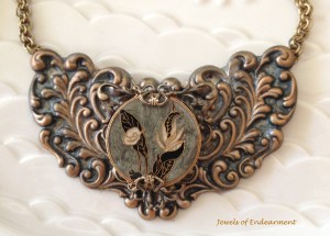 Flowers and Ferns Necklace This Clossine centerpiece was originally designed in late 1800s, made of multiple layers of different materials such as enamel, metal and crystal. Layered on a lovely Floral Filigree Embellishment