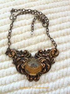 Rising Sun Necklace A glorious golden sunrise is set on a feathery motif centerpiece with chocolate and golden tones.