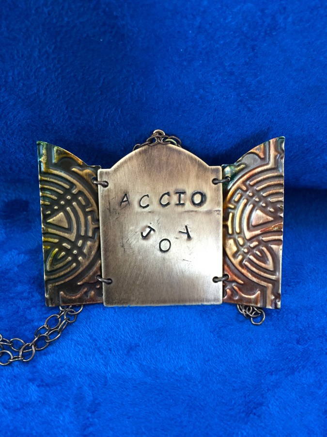 Accio Joy Doorway Necklace Open the door to joy with a hand tinted and embellished necklace
