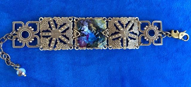 Searching Woman Bracelet    An art deco inspired woman softly shines through an opalescent swirl of lilac, pearl and midnight blue.